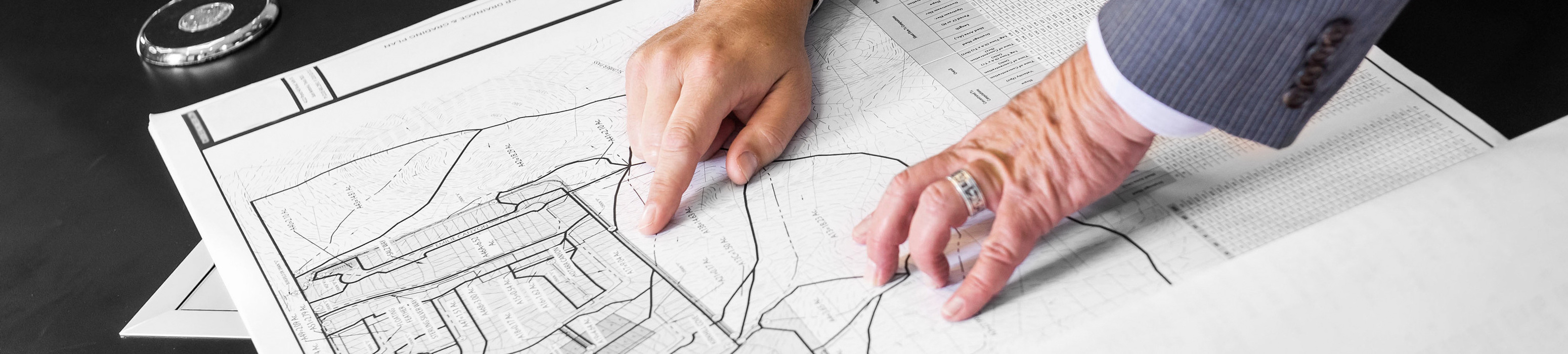 Two people looking over a blueprint scematic