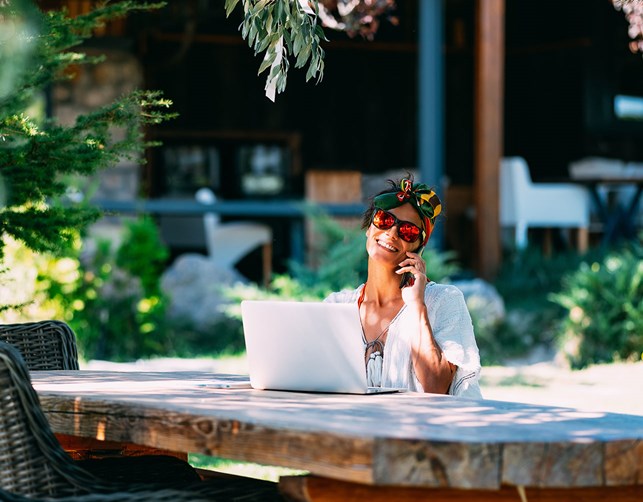 A woman working on her computer outside